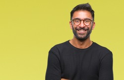 Adult hispanic man wearing glasses over isolated background happy face smiling with crossed arms looking at the camera. Positive person.