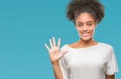 Young afro american woman over isolated background showing and pointing up with fingers number five while smiling confident and happy.