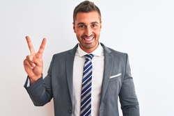 Young handsome business man wearing suit and tie over isolated background showing and pointing up with fingers number two while smiling confident and happy.