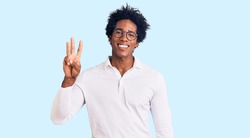 Handsome african american man with afro hair wearing casual clothes and glasses showing and pointing up with fingers number three while smiling confident and happy. 