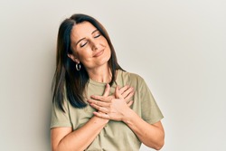 Middle age brunette woman wearing casual clothes smiling with hands on chest, eyes closed with grateful gesture on face. health concept. 