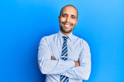 Hispanic adult man wearing business shirt and tie happy face smiling with crossed arms looking at the camera. positive person. 