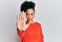 Young african american girl wearing casual clothes doing stop sing with palm of the hand. warning expression with negative and serious gesture on the face. 
