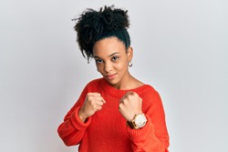 Young african american girl wearing casual clothes ready to fight with fist defense gesture, angry and upset face, afraid of problem 