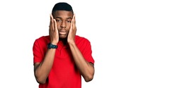 Young african american man wearing casual red t shirt tired hands covering face, depression and sadness, upset and irritated for problem 