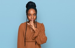 Young african american woman wearing casual clothes asking to be quiet with finger on lips. silence and secret concept. 
