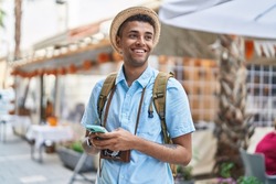 African american man tourist smiling confident using smartphone at street