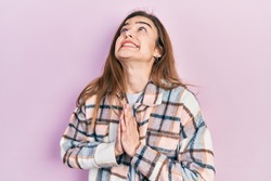 Young caucasian girl wearing casual clothes begging and praying with hands together with hope expression on face very emotional and worried. begging. 