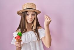 Teenager girl holding ice cream doing italian gesture with hand and fingers confident expression 