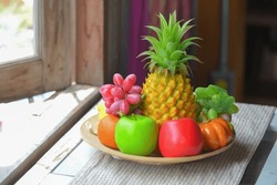 Artificial fruit, in a container, an attention-grabbing concept.