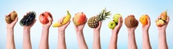 Various hands holding assorted fruits in a banner format.Banana, pineapple, apple and many other hands on diet background.