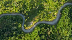 Aerial view of hilly region borneo showing forests, roads and slopes.