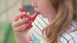 Young Caucasian Girl Blowing Porcelain Bird Whistle Water Whistle Toy Playing High Pitch Vibrating Sound 