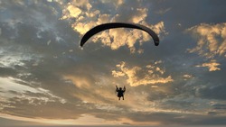sunset with paragliding in the sky