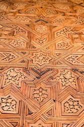 Detail of a carved wooden door in the Alhambra, Granada, Spain.Arab door carved with Islamic style. 