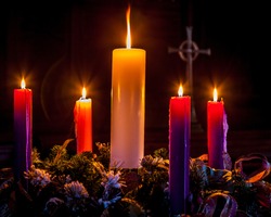 Advent candles glow and mark the celebration of Christmas/Advent Wreath