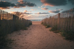 Sandy walkway down to the beach and ocean during a beautiful sunrise