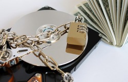 Information security concept. The data is a locked hard drive. The concept of paying money to save the data.