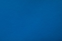 Blue background with paper texture, horizontal, blank space.
