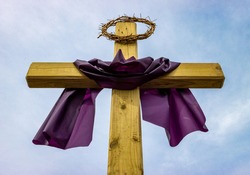 Jesus crown of thorns on top of wooden post outside Christian religious church during Lent before Easter holiday