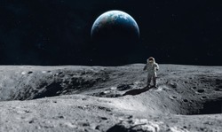 Astronaut stay on the Moon surface against Earth on the background, Exploring space and other planets