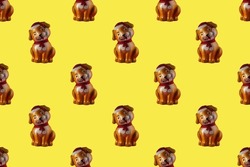 Abstract children's seamless background with dogs. Lots of beautiful toy dogs on a yellow background.