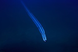 speed boat passenger and water splash blue sea background at night aerial top view from drone