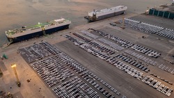 Aerial View of new cars parked at the parking area of automobile factory. Waiting for RORO transport
