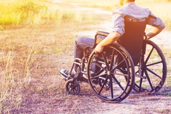 Paralyzed man using Wheelchair outdoor 
