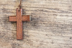 simple wooden Christian cross  on the old wood texture