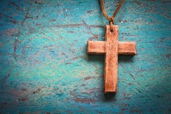 Image of wooden cross on blue retro background
