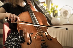 A female musician playing the cello.