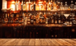 Liquor bar background in softfocus with woonden table