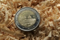 Spanish 2 Euro coin Escorial 2013. Bimetallic coin in wood chips. European circulating commemorative coin.