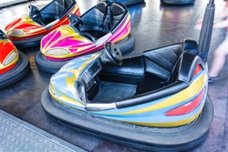 Colorful bumper cars, racing cars in amusement park, racing with bumps.