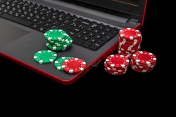 Gambling online casino Internet betting concept. Jackpot, casino chips. computer keyboard, laptop with poker chips, dice. Casino tokens, gaming chips, checks, or cheques.