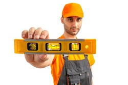 Worker using a ruler with a water level. Staff in a uniform cap, orange t-shirt, and overalls on a white isolated background.