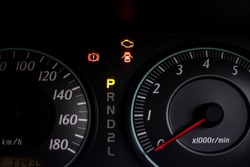 The warning lights of car engine check, parked and hand break in the speedometer of a vehicle