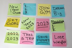 New Year 2023 goals hand written on a sticky notes on a white isolated background