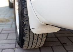 Car mudguard or mudflap of a rear wheel