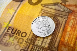 Poland — March 09 2022: In this photo illustration the reverse of the Russian 1-ruble coin with emblem of the Bank of Russia and the 50-euro note are seen displayed