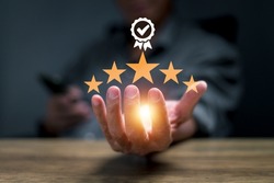 businessman hand showing sign of top service 5-star quality assurance, warranty, standardization, ISO certification, and standardization concept.