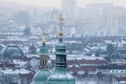 Church towers and rooftops of Graz in Austria on a cold winter morning