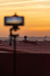 Blurred smartphone recording fantastic sunset time-lapse 