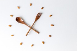 clock, wood spoon and fork clock, bamboo cutlery, almond nuts, almonds, clock on white background, lunch time breakfast time, meal time, healthy eating, eco-friendly, eco-friendly