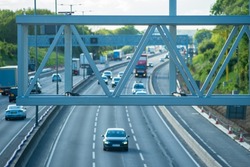new built smart motorway traffic sign holder structure over moving traffic in england uk