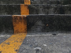 Yellow lines on the stairs.
Stairs are painted with yellow lines. A picture of a staircase painted with yellow lines divided into steps.