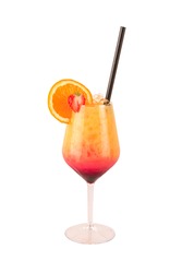 Tequila sunrise cocktail large wine glass decorated with a wheel of orange and half of strawberry with black straw isolated on white background Layered color drink with orange juice and grenadine