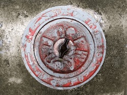 Vintage Red Fire Hydrant Cover on Concrete Surface