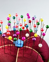 Colourful sewing accessories pearl head pins. They are supporting tools for clothing sewing process